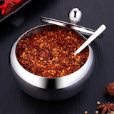 FlavorVault stainless steel seasoning pot with lid | Kitchen spice container holding salt and pepper | FlavorVault used to store herbs and spices | Compact stainless steel spice jar on countertop | Seasoning pot with airtight lid for freshness | FlavorVault spice pot with modern kitchen design | Sleek stainless steel container for kitchen spices | FlavorVault holding ground pepper and curry powder | Durable spice storage pot with easy-grip lid | FlavorVault seasoning pot beside cooking utensils

