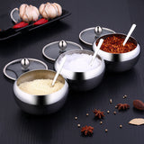 FlavorVault stainless steel seasoning pot with lid | Kitchen spice container holding salt and pepper | FlavorVault used to store herbs and spices | Compact stainless steel spice jar on countertop | Seasoning pot with airtight lid for freshness | FlavorVault spice pot with modern kitchen design | Sleek stainless steel container for kitchen spices | FlavorVault holding ground pepper and curry powder | Durable spice storage pot with easy-grip lid | FlavorVault seasoning pot beside cooking utensils

