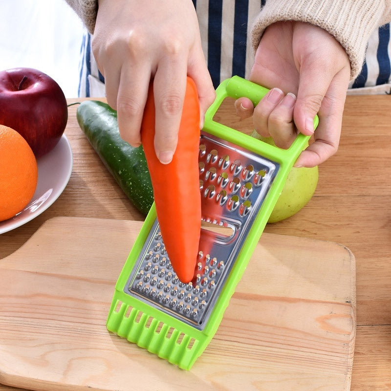 KitchenSwift manual chopper and grater on kitchen counter | Stainless steel blades chopping vegetables in KitchenSwift | KitchenSwift slicing carrots with multi-blade insert | Manual kitchen grater with anti-slip base | Multifunctional chopper dicing onions and garlic | Compact grater and slicer with stainless steel design | KitchenSwift prepping salad ingredients on cutting board | Handheld food chopper with safety handle and blade guard