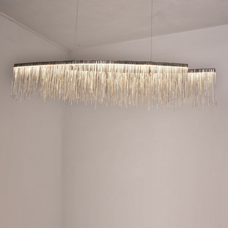LumaGlow minimalist chandelier in dining room | Modern ceiling light fixture above dining table | Sleek chandelier with warm ambient lighting | Personalized chandelier installed in living room | Minimalist LED chandelier hanging in open space | Custom LumaGlow chandelier above modern dining setup | Elegant black and gold chandelier in minimal interior | Contemporary ceiling light with clean design | Scandinavian-style chandelier lighting a cozy room | Linear pendant chandelier for modern home décor