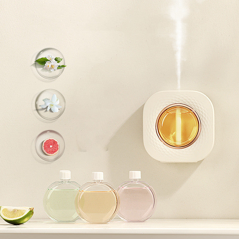 Wall-mounted aroma diffuser | ScentMount on desktop releasing mist | Compact essential oil diffuser | Aroma diffuser with LED light | Automatic scent diffuser on table | Mounted diffuser in modern room | ScentMount with essential oils | Quiet ultrasonic diffuser in use