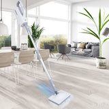 SteamMate electric steam mop cleaning tile floor | 2-in-1 steam mop and handheld cleaner in use | SteamMate removing stains from hardwood flooring | Multifunctional steam mop with detachable handheld unit | High-temperature steam mop sanitizing kitchen floor | Lightweight electric mop gliding across laminate floor | Handheld steam cleaner attachment disinfecting surface | SteamMate with removable water tank for easy refills | Compact steam mop standing upright on bathroom tiles | Chemical-free steam mop cle